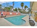 Backyard pool with a large deck area and colorful brick retaining wall provides a private oasis at 1904 Chapman Dr, Las Vegas, NV 89104