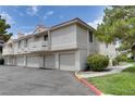 A condo building with private garages and desert landscaping on a sunny day at 2633 S Durango Dr # 202, Las Vegas, NV 89117