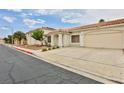 Inviting single-story home with a two-car garage, desert landscaping, and tiled roof at 2865 Destino Ln, Henderson, NV 89074