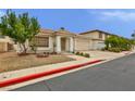 Well-maintained single-story home with desert landscaping, tile roof, and two-car garage at 2865 Destino Ln, Henderson, NV 89074