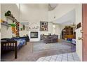 Open living area with a cozy fireplace, vaulted ceiling and lots of natural light at 3359 Commendation Dr, Las Vegas, NV 89117