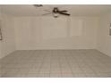 Spacious living room featuring tile flooring and a ceiling fan for added comfort at 3633 Monte Verde St, Las Vegas, NV 89121