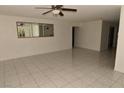 Bright living room showcasing neutral walls, tile flooring, and ample space for furniture at 3633 Monte Verde St, Las Vegas, NV 89121