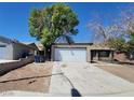 Street view of a single-story home with detached garage at 3755 Chutney St, Las Vegas, NV 89121