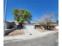 Single-story home with a detached garage, curb appeal and desert landscaping at 3755 Chutney St, Las Vegas, NV 89121