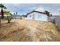Spacious backyard featuring a partially wooden fence and desert landscaping at 4303 Paramount St, Las Vegas, NV 89115