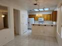 Kitchen features tile floors, wood cabinets, and a breakfast bar, perfect for casual dining at 438 Fountain Grove St, Henderson, NV 89012