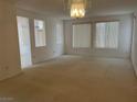 Spacious living room with neutral carpet, ample natural light, and decorative chandelier at 438 Fountain Grove St, Henderson, NV 89012