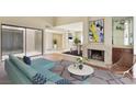 Living room with fireplace, modern furnishings, and sliding door access to outdoor courtyard at 4687 Madreperla St, Las Vegas, NV 89121