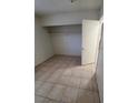 Cozy bedroom features neutral walls, tiled flooring, and a closet for storage at 500 Prescott St, Las Vegas, NV 89110
