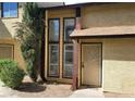 Townhome featuring an ornate security door, large windows, and tidy xeriscape at 513 Kristin Ln, Henderson, NV 89011
