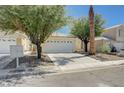 Inviting one-story home with a well-maintained front yard and attached two-car garage at 6009 Flowering Plum Ave, Las Vegas, NV 89142