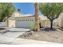 Attractive single-Gathering home featuring an attached two-car garage and desert landscaping at 6009 Flowering Plum Ave, Las Vegas, NV 89142