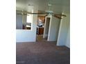 Living room with neutral carpet and an open concept layout with a view to the kitchen at 733 Hitchen Post Dr, Henderson, NV 89011