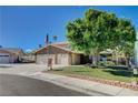 Charming two-story home featuring a three-car garage and mature landscaping at 902 Dianne Dr, Boulder City, NV 89005