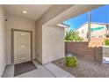 Cozy covered porch featuring desert landscaping and a security screen door for added privacy at 9113 Sea Mink Ave, Las Vegas, NV 89149