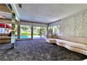 Spacious living room with views of the pool from the expansive windows at 940 Vegas Valley Dr, Las Vegas, NV 89109