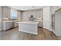 Open kitchen with white cabinets, stainless steel appliances, and kitchen island at 10058 Matter Overlook Dr, Las Vegas, NV 89178