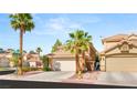 Inviting two-story home with desert landscaping, two-car garage, and tile roof at 1125 Lumina Ct, Las Vegas, NV 89117