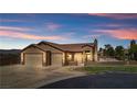 Charming single-story home boasting a three-car garage and lush desert landscaping at 1204 Golf Club, Laughlin, NV 89029