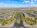 Panoramic aerial view of a Primary-planned community surrounded by mountains at 12415 Notch Trail Ave, Las Vegas, NV 89138