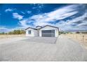 Beautiful modern home with gray accents, desert landscaping, and mountain views at 2461 S Blagg Rd, Pahrump, NV 89048