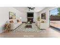 Light filled living room with modern furniture, a black fireplace and access to the back yard at 2724 Natalie Ave, Las Vegas, NV 89121
