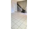 An open living room space featuring tile floors, fresh paint and stairs to the next level at 3453 Del Marino Dr, Las Vegas, NV 89121