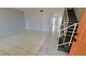 Spacious living room with tile flooring, modern finishes, and stairs to the second floor at 3453 Del Marino Dr, Las Vegas, NV 89121