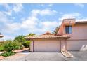 A charming home exterior shows a two-car garage and a red-tiled roof under blue skies at 3629 Laguna Verde Way, Las Vegas, NV 89121
