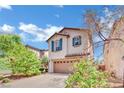 Charming two-story home featuring a well-manicured lawn, a two-car garage, and decorative shutters at 3741 Via Gaetano, Henderson, NV 89052
