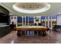 Stylish game room with a classic billiard table, dark wood floors, and stunning city views at 3750 S Las Vegas Blvd # 4507, Las Vegas, NV 89158