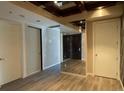 Spacious room featuring hardwood floors with doors and a mirrored wall at 4575 Dean Martin Dr # 705, Las Vegas, NV 89103