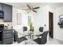 Modern dining area boasts a glass-top table, stylish black chairs, and kitchen appliances at 4955 Jeffreys St # 605, Las Vegas, NV 89119