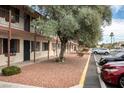 Two-story apartment building with red rock landscaping, mature olive trees, and parking in front at 4955 Jeffreys St # 605, Las Vegas, NV 89119