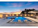 A serene backyard showcases a pool with in-pool chairs, a hot tub and a covered outdoor bar at 5081 Notting Hill Ave, Las Vegas, NV 89139