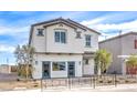 Inviting two-story home with neutral stucco, grey roof, and blue doors at 7437 Cooper Cove Dr # 30, North Las Vegas, NV 89084