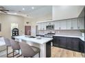 Bright modern kitchen with stainless steel appliances, an island, and light countertops at 7772 Buckwood Ct, Las Vegas, NV 89149