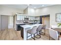 Updated kitchen with modern appliances, an island, updated tile backsplash and light countertops at 7772 Buckwood Ct, Las Vegas, NV 89149