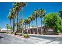 Paloma at Sienna Vistas gated community entrance with mature palm trees and manicured landscaping at 7820 Esteem St, Las Vegas, NV 89131