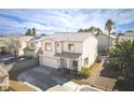 Two-story home featuring a two-car garage, desert landscaping, and a tile roof at 7820 Esteem St, Las Vegas, NV 89131