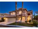 Lovely two-story home with a three-car garage, complemented by palm trees and landscaping at 9583 Gainey Ranch Ave, Las Vegas, NV 89147