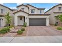 Two-story home features a tile roof, desert landscaping, and a two-car garage at 9947 Fletcher Peak Ave, Las Vegas, NV 89178
