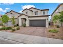 Two-story home features a tile roof, desert landscaping, and a two-car garage at 9947 Fletcher Peak Ave, Las Vegas, NV 89178