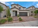 Two-story home features a tile roof, desert landscaping, and a two-car garage at 9947 Fletcher Peak Ave, Las Vegas, NV 89178