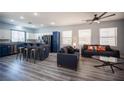 Open living space with a modern kitchen, bar seating, and comfortable furnishings at 10628 Calf Creek Ct, Las Vegas, NV 89129