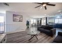 Open floor plan showcasing the living room, staircase, and dining area with kitchen access at 10628 Calf Creek Ct, Las Vegas, NV 89129