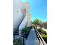 Exterior walkway with stairs leading to the entrance and surrounded by manicured landscaping at 1521 Ruby Cliffs Ln # 104, Las Vegas, NV 89144
