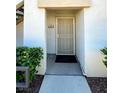 Welcoming front door featuring a security screen, unit number and fresh exterior paint at 1521 Ruby Cliffs Ln # 104, Las Vegas, NV 89144