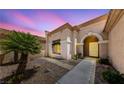 Elegant single-story home featuring a covered entryway, desert landscaping, and neutral exterior paint at 1900 Bellview St, Las Vegas, NV 89134